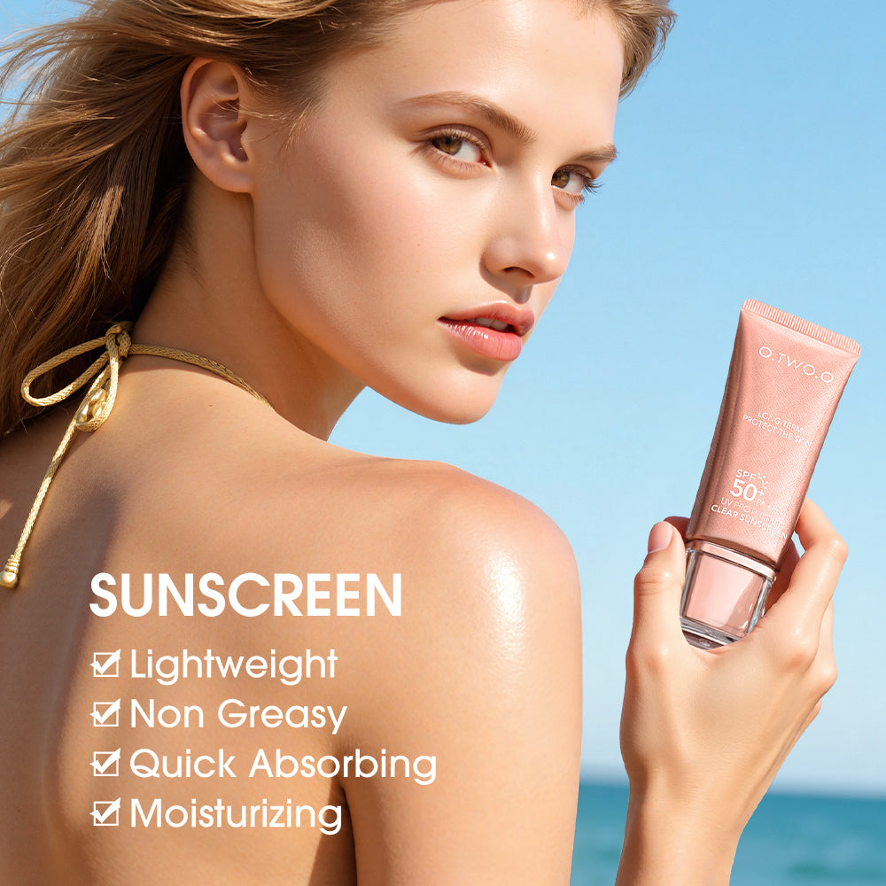Woman holding a sunscreen product with a clear blue sky background